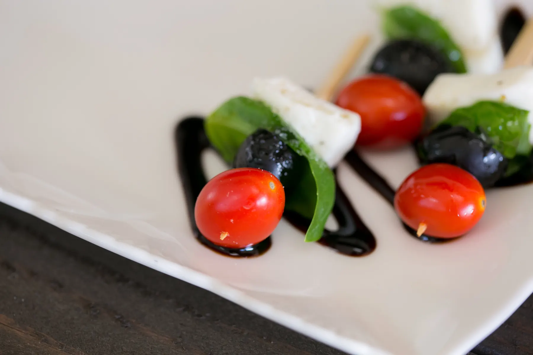 Caprese kabobs with fresh mozzarella, basil, cherry tomatoes and balsamic reduction