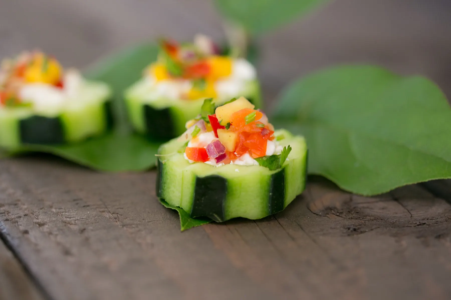 Mediterranean cucumber cups topped with feta, tomatoes and olives